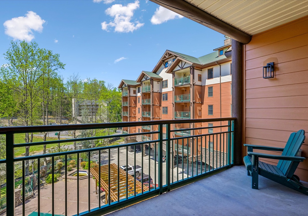 Step onto your private balcony and sink into the comfortable chair while taking in views of the charming resort buildings and lush surroundings.