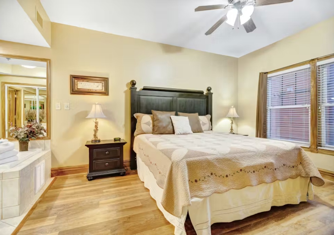 Rest peacefully in your elegant bedroom with plush bedding, warm lighting, and gentle ceiling fan keeping you comfortable all night.