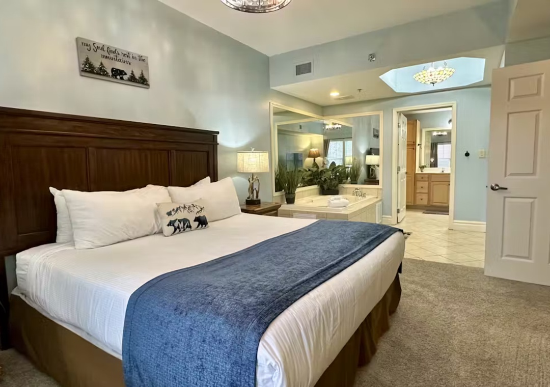 Drift into luxury in this spacious bedroom with plush bedding and elegant mountain-themed touches that welcome you to your perfect retreat.