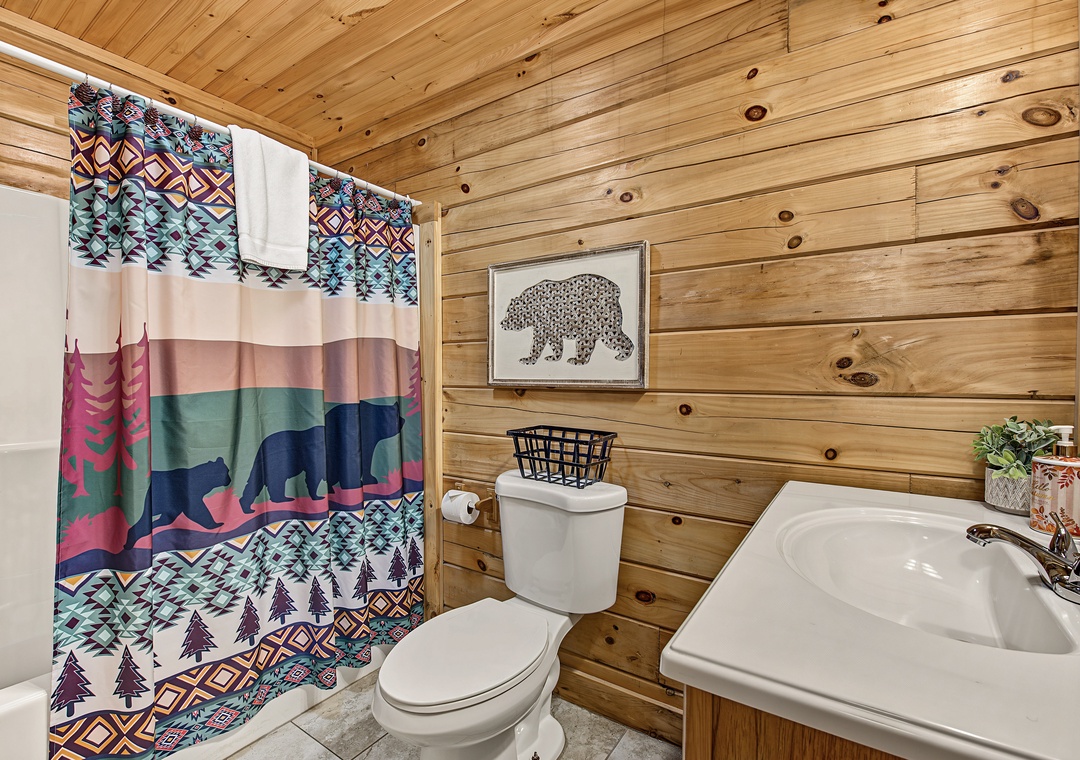 Rustic wood walls and playful cabin-inspired accents make freshening up feel like part of the mountain getaway. Your towels are waiting.