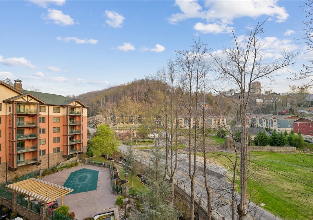 Property overlooks scenic mountain landscape with nearby recreational facilities and green spaces in a peaceful setting.