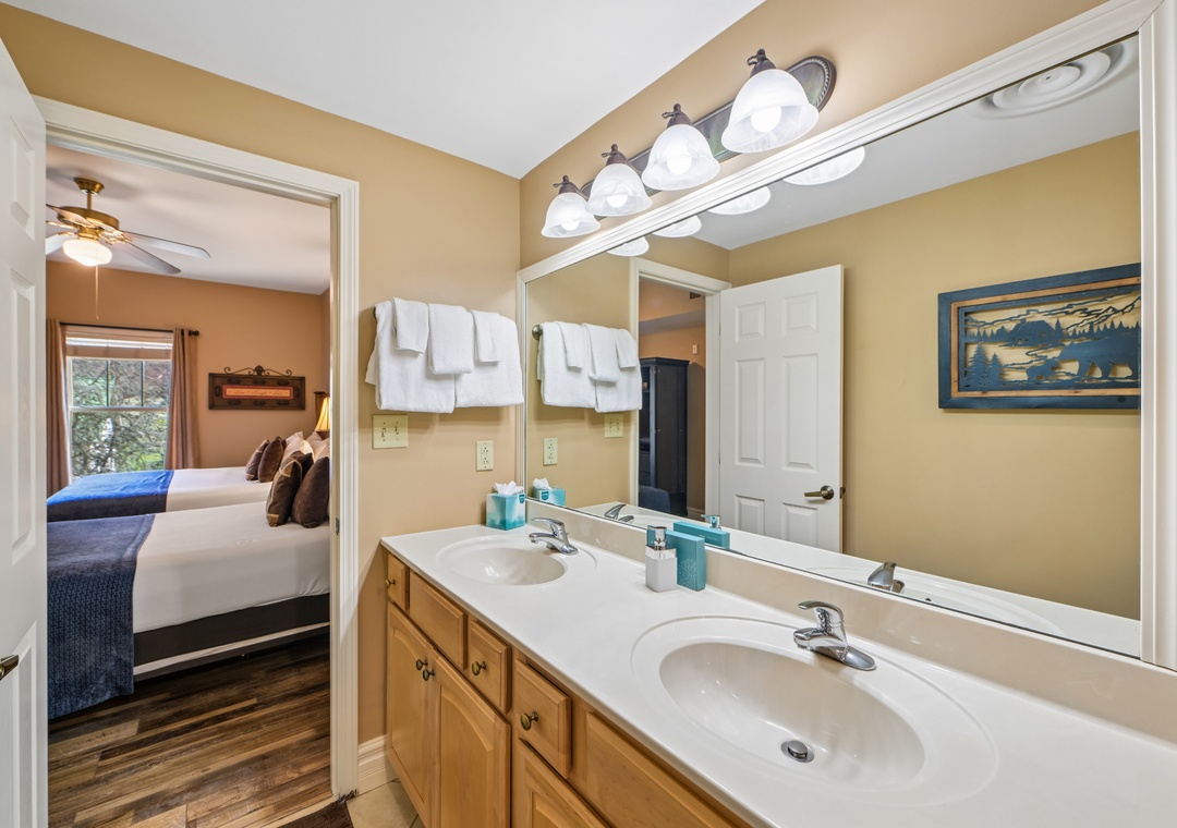 Your private ensuite bathroom features dual sinks and thoughtful amenities, connecting seamlessly to your comfortable bedroom retreat.