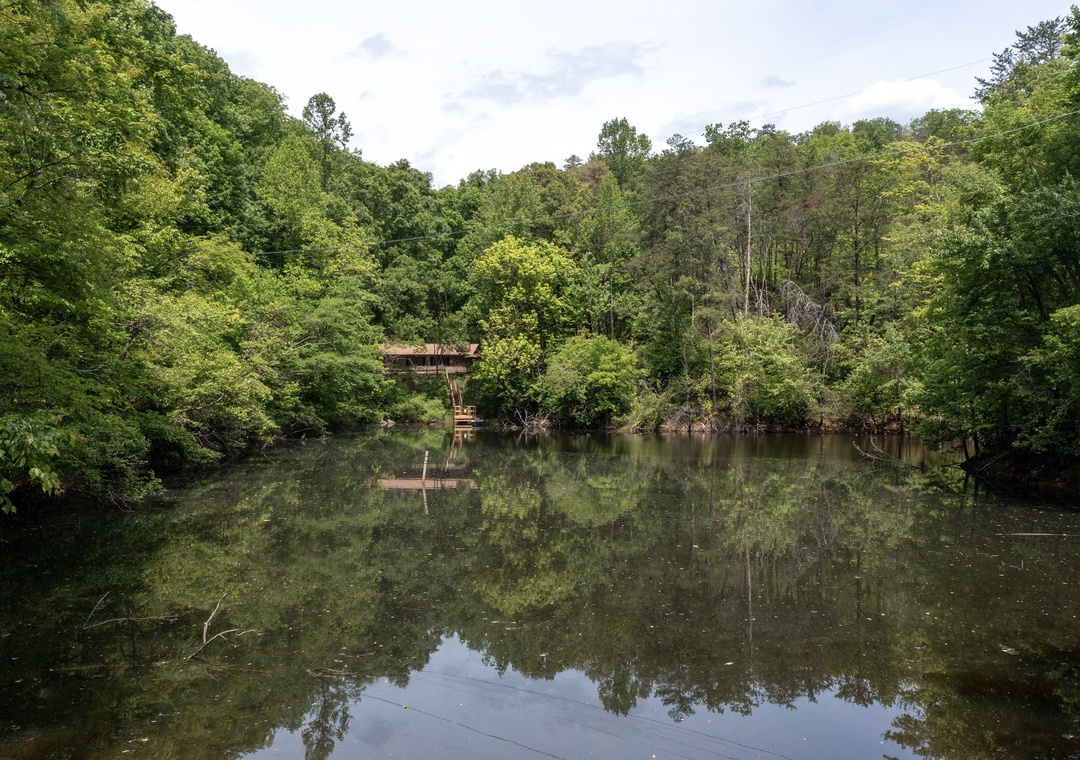 A serene lakefront retreat surrounded by lush forest, offering peaceful natural scenery and private waterfront access for relaxation and outdoor recreation.