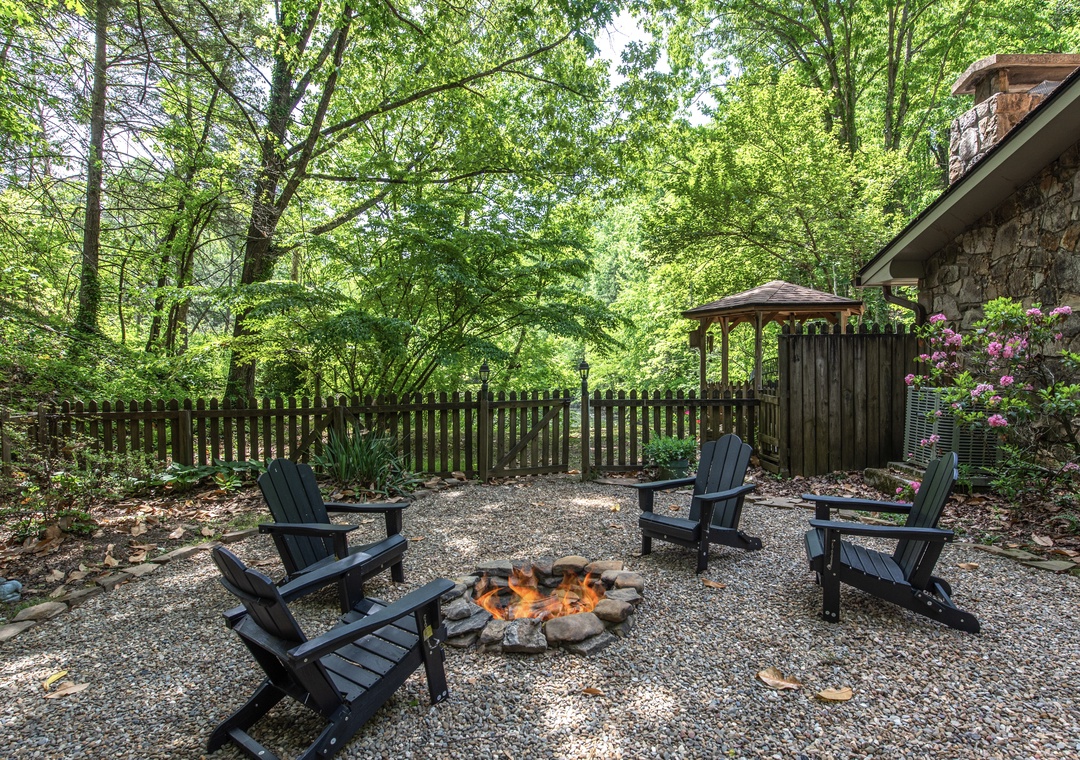 Picture yourself gathered around the crackling fire pit, surrounded by lush forest canopy and cozy Adirondack chairs—your perfect spot for evening stories and s'mores under the trees.