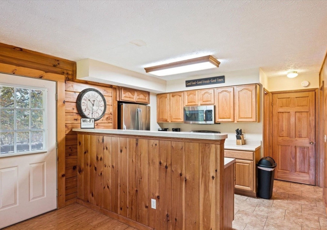 Step into your rustic-chic kitchen with warm knotty pine cabinets, stainless steel appliances, and granite counters perfect for cooking memorable meals.