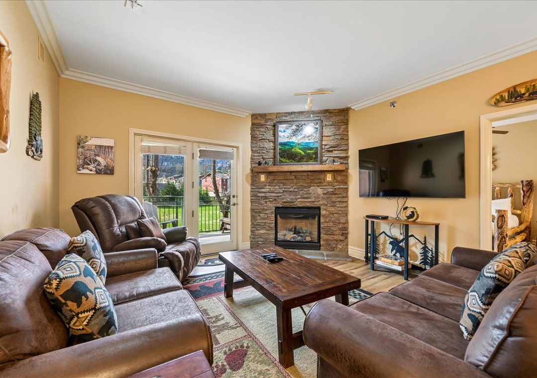 Sink into plush leather recliners by your crackling stone fireplace, where mountain warmth meets modern comfort in your cozy retreat.