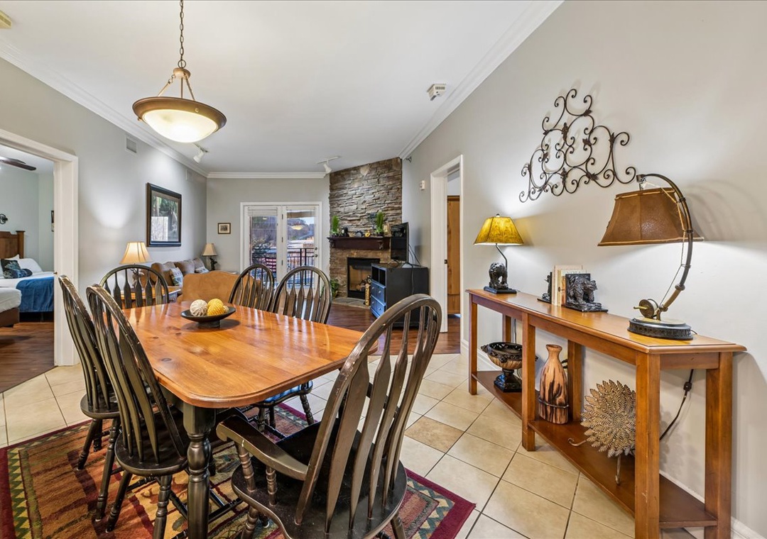 Gather around the beautiful wooden dining table for memorable meals with your group, surrounded by elegant details and warm lighting.
