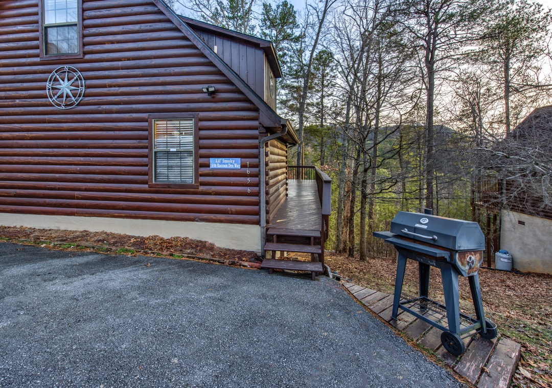 Charming log cabin exterior featuring convenient parking and your own private BBQ grill for perfect outdoor dining experiences.