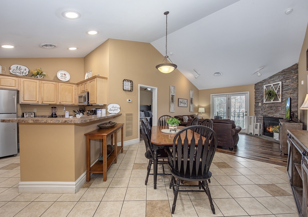 Gather around your spacious kitchen island for morning coffee, then relax by the stone fireplace in this beautifully designed open living space.