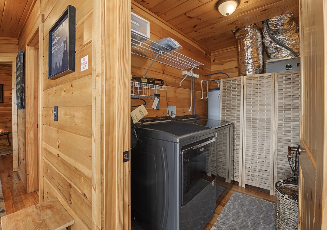 This dedicated laundry space keeps your getaway convenient, with a washer, storage shelves, and warm pine finishes throughout.