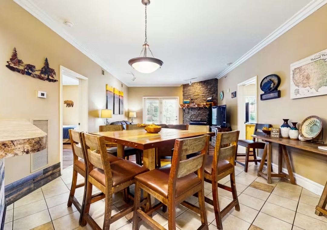 Gather around this handcrafted wood dining table where mountain memories are shared over home-cooked meals beneath warm pendant lighting.