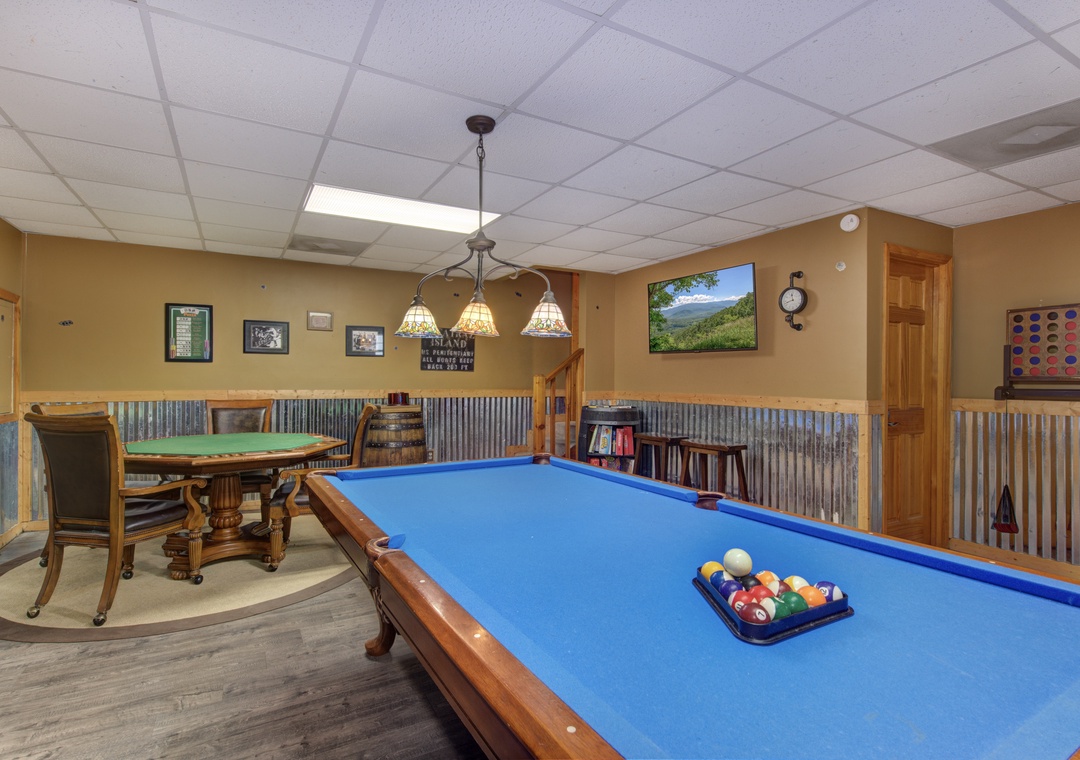 Challenge your friends to billiards in this inviting game room, complete with elegant lighting and cozy seating areas for everyone to enjoy.