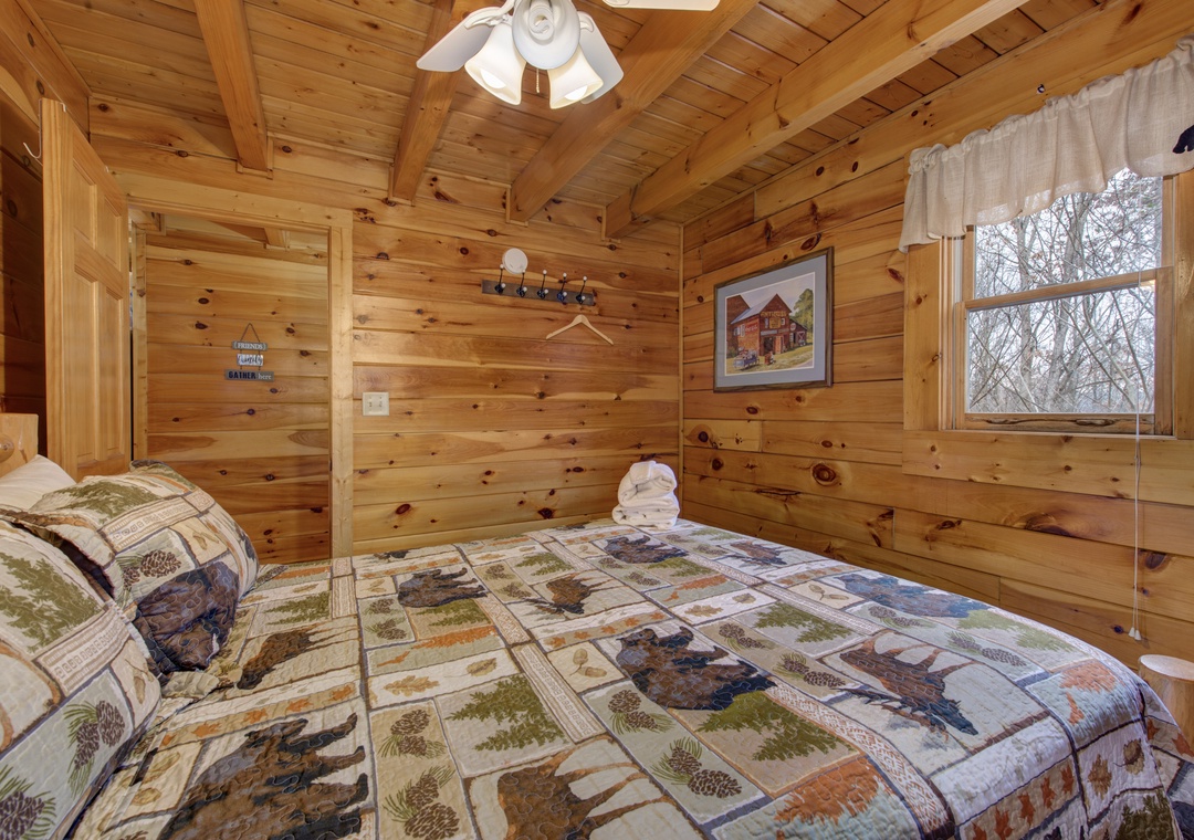 Drift off in your cozy log cabin bedroom, wrapped in rustic charm with nature-themed bedding and forest views beyond your window.