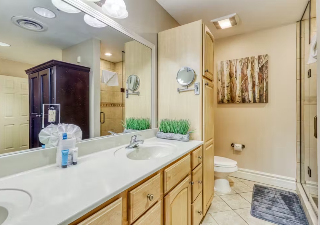 Your spacious bathroom features dual vanities, elegant storage, and a relaxing shower—perfect for your morning routine.
