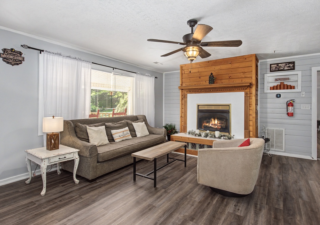 Relax in this cozy living room with a crackling fireplace, comfortable seating, and rustic charm that makes you feel right at home.