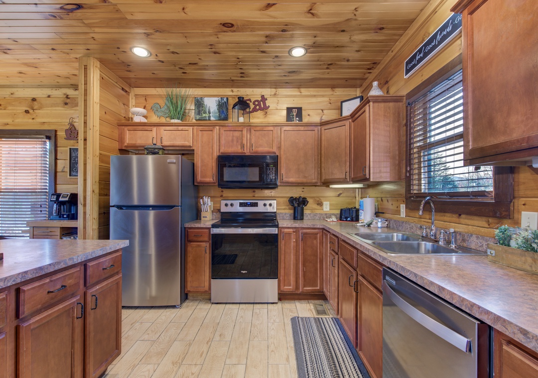 Step into your fully-equipped kitchen with warm wood finishes, stainless steel appliances, and everything you need to create memorable meals during your mountain getaway.