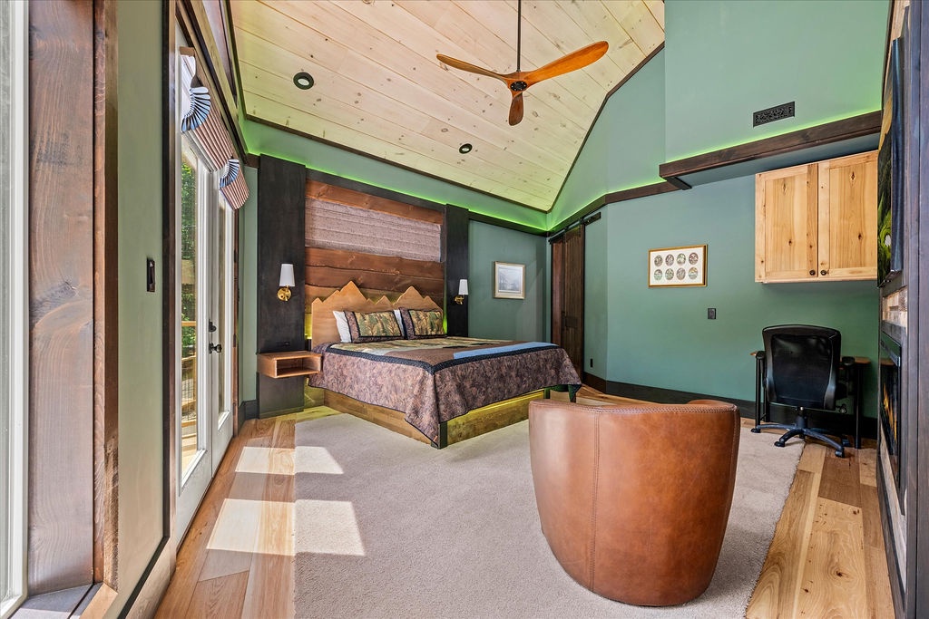 Unwind in your spacious retreat with vaulted ceilings, natural light streaming through large windows, and a cozy seating area perfect for relaxing after a day of adventure.