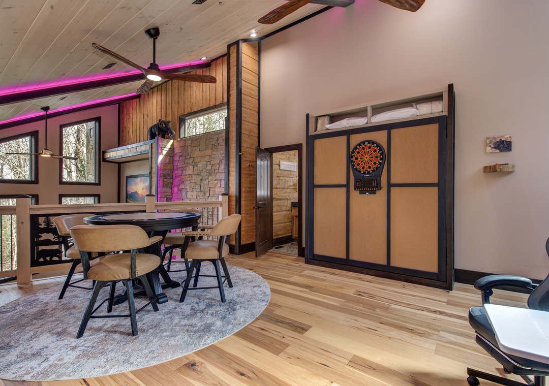 Unwind in your spacious game room where friends gather around the stylish table while dartboard awaits your competitive spirit.
