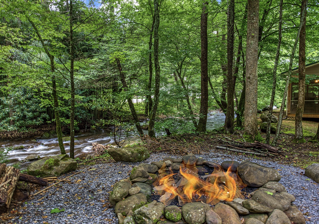 Gather around the fire pit as the stream flows gently beside you, creating the perfect setting for peaceful evenings surrounded by nature's beauty.
