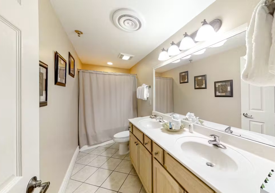Your spacious bathroom features a large vanity with ample storage, perfect for getting ready each morning in comfort.