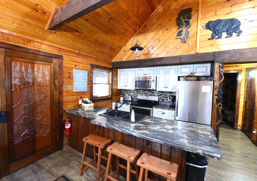 Your rustic kitchen features granite counters, stainless appliances, and charming woodland décor—perfect for preparing mountain meals together.