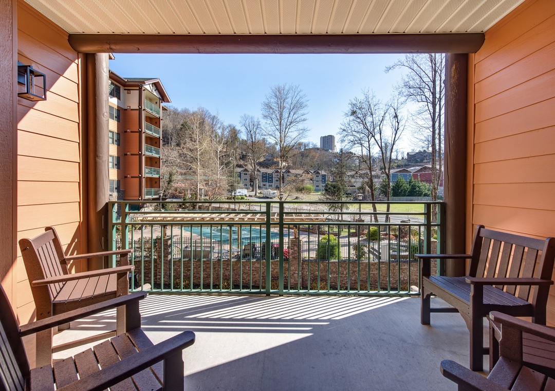 Step onto your private balcony and soak in stunning pool views while sipping morning coffee from comfortable wooden chairs.