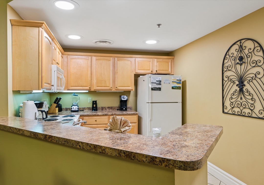 Your fully equipped kitchen awaits with granite counters, maple cabinets, and everything you need to create memorable meals during your stay.