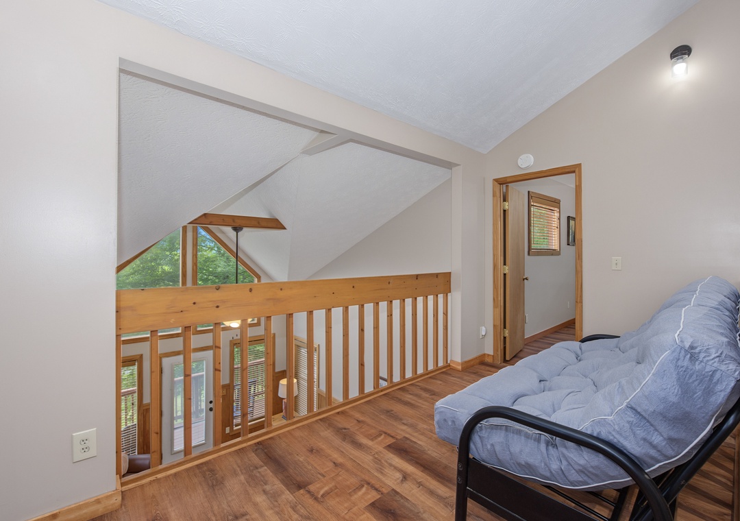 This cozy loft space overlooks the main level below, offering you a quiet nook to relax with your favorite book or simply enjoy the natural light streaming through the windows.