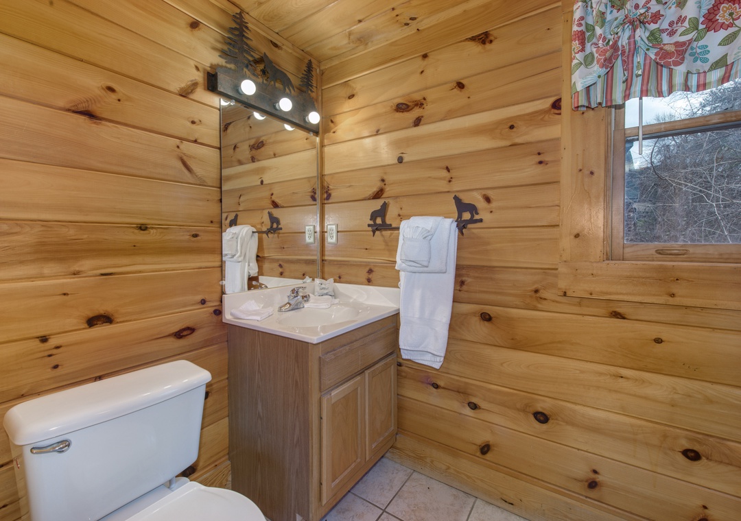 Warm wood walls surround you in this cozy cabin bathroom, with rustic details and all the comforts you need for a peaceful mountain getaway.