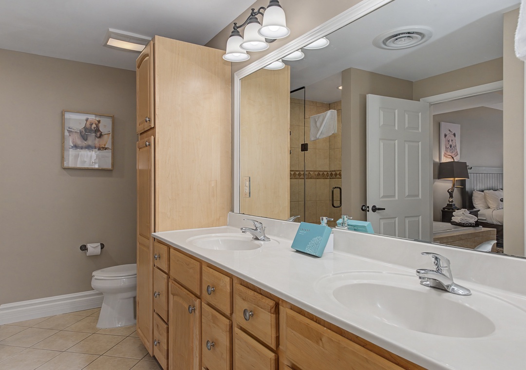 Your spacious bathroom features dual sinks and ample storage, perfect for getting ready together each morning.