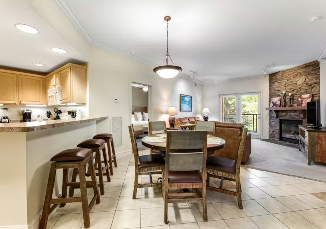Gather around your spacious dining table while meals simmer in the full kitchen, then unwind by the stone fireplace in this open-concept retreat.