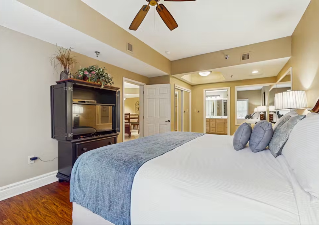 Unwind in your spacious master suite featuring a plush bed, entertainment center, and ensuite bathroom for complete comfort.