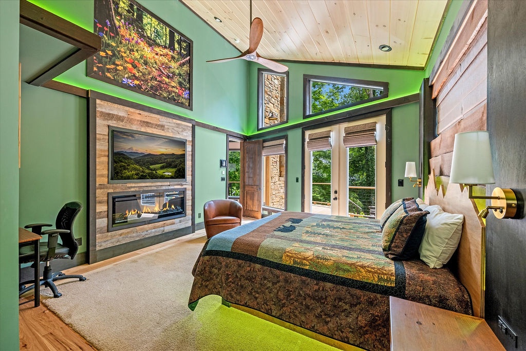 Wake up in your stunning bedroom with soaring ceilings, a cozy fireplace, and doors opening to nature. Vibrant green walls, warm wood accents, and art-filled spaces make this retreat uniquely yours.