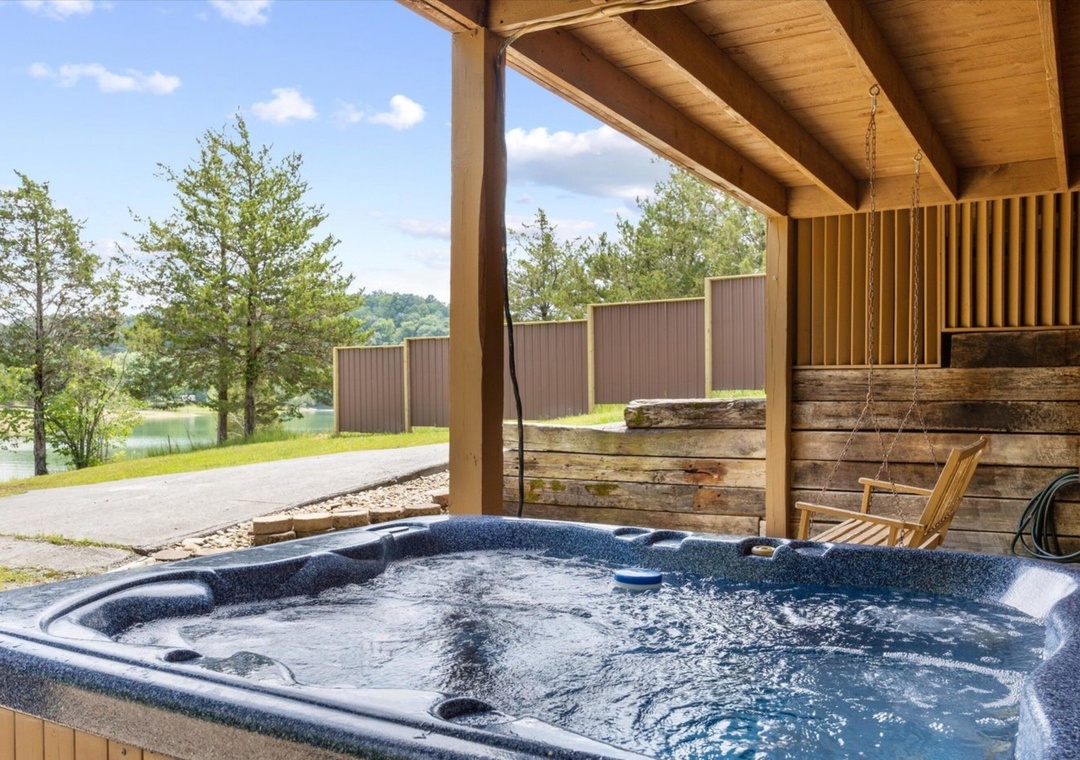 Soak in your private hot tub while gazing at serene lake views, surrounded by natural beauty and rustic charm.