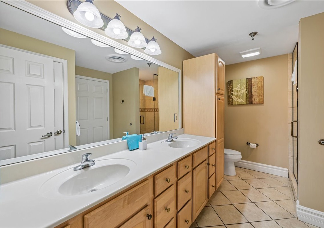 Your spacious bathroom features dual sinks and ample storage, perfect for preparing for your day in comfort.