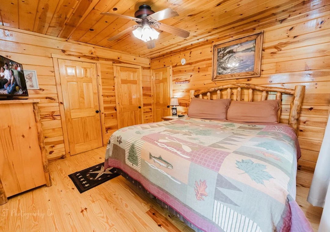 Unwind in your cozy cabin bedroom featuring warm pine walls, a handcrafted log bed, and rustic touches that make you feel right at home in the mountains.