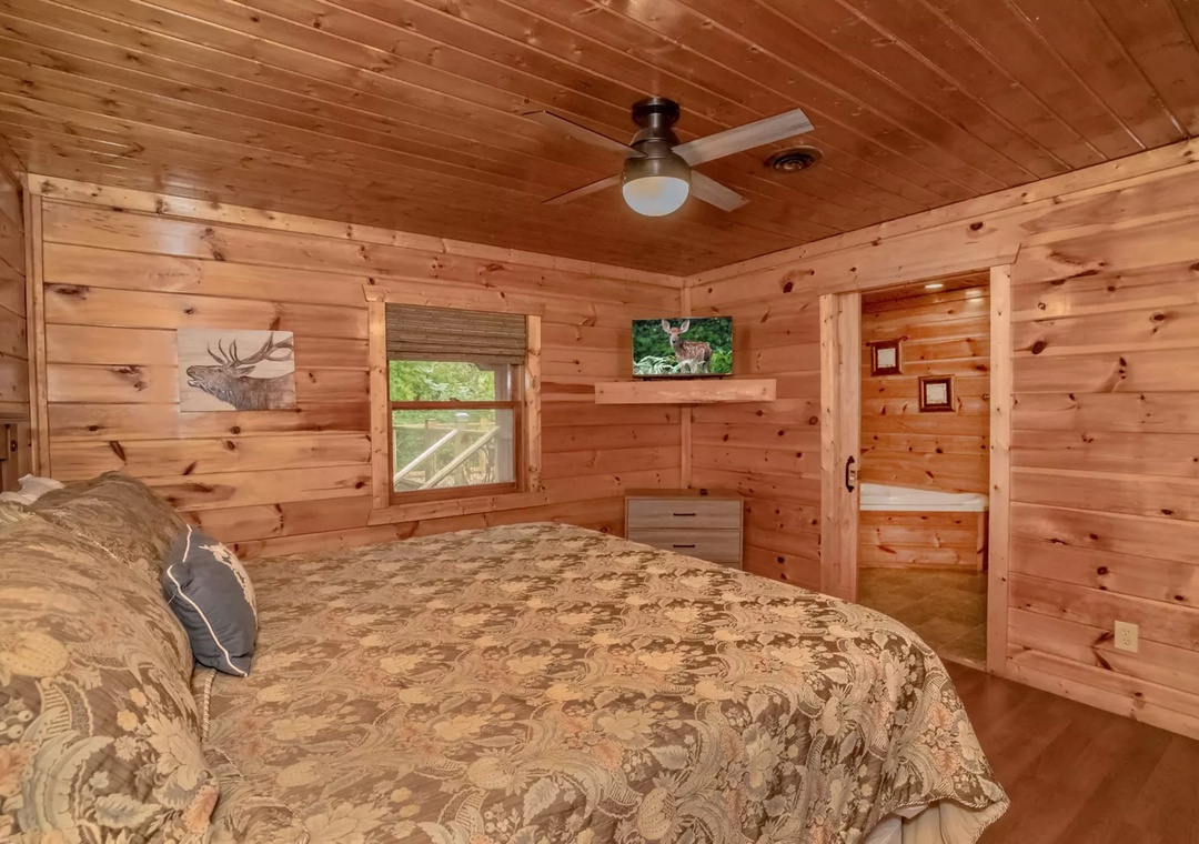 Drift off to sleep surrounded by warm wood walls and rustic charm in your cozy cabin bedroom retreat.