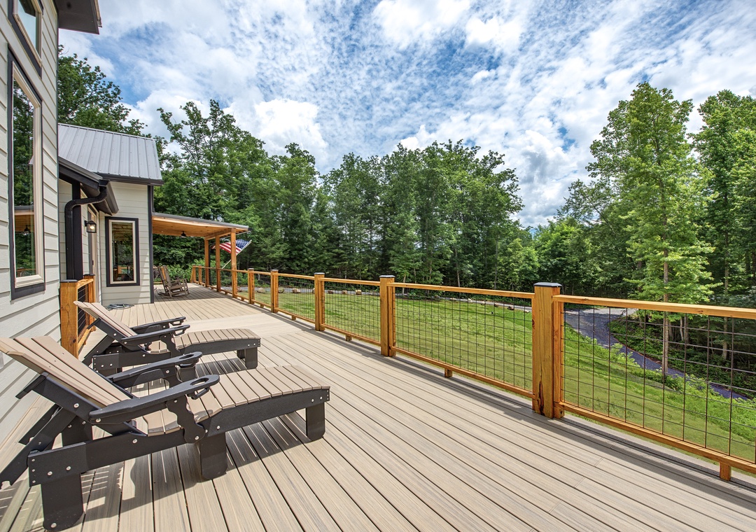 Stretch out on your private deck with lounge chairs and sweeping views of lush greenery—perfect for morning coffee or sunset relaxation.