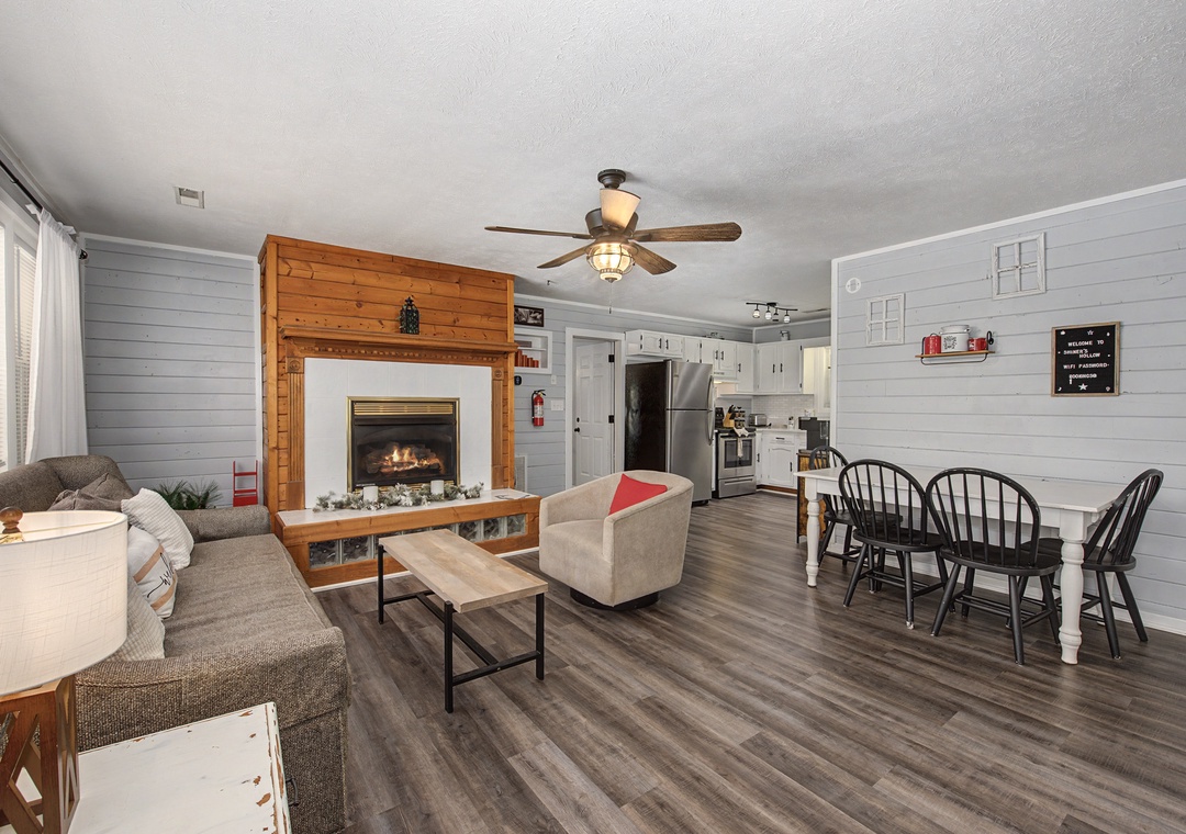 Cozy up by your gas fireplace while enjoying the open-plan living space with modern kitchen and charming farmhouse details.