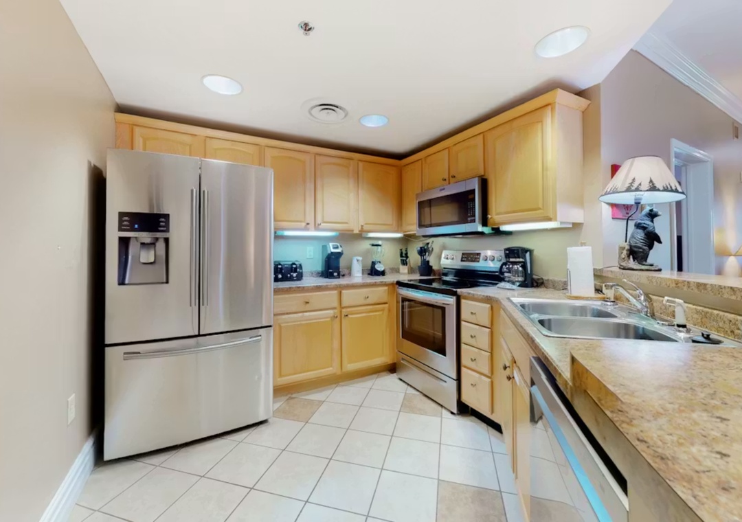 Your fully equipped kitchen invites culinary adventures with granite countertops, stainless appliances, and warm wood cabinetry creating the perfect cooking retreat.