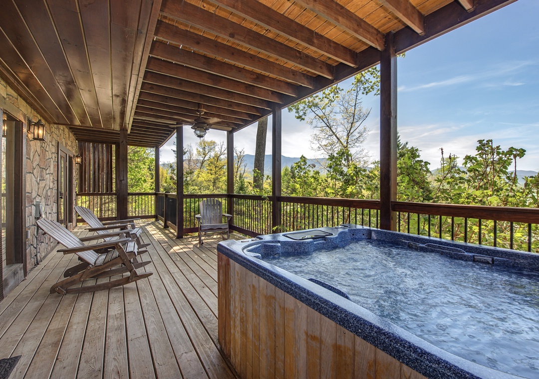 Soak in the bubbling hot tub on your private covered deck while taking in breathtaking mountain views through the trees.