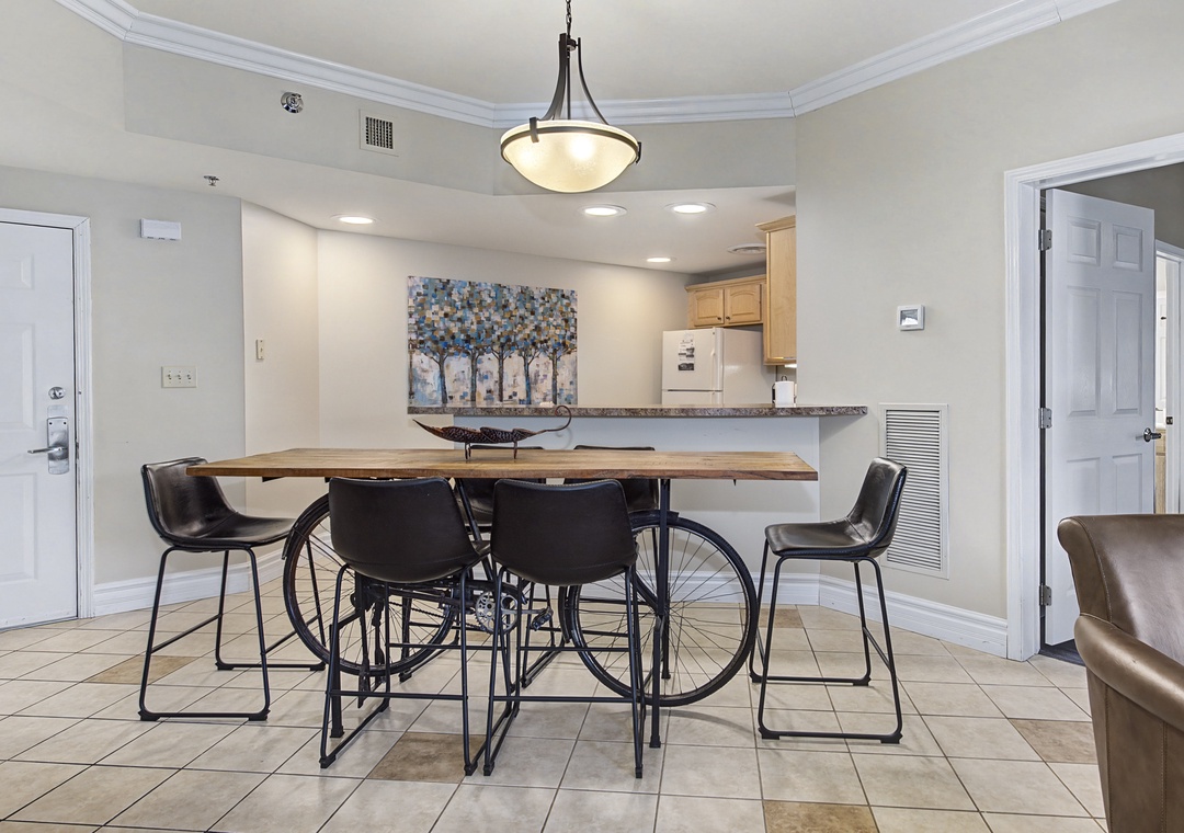 Your stylish dining area flows seamlessly into the kitchen, where warm pendant lighting creates the perfect atmosphere for meals and conversations.