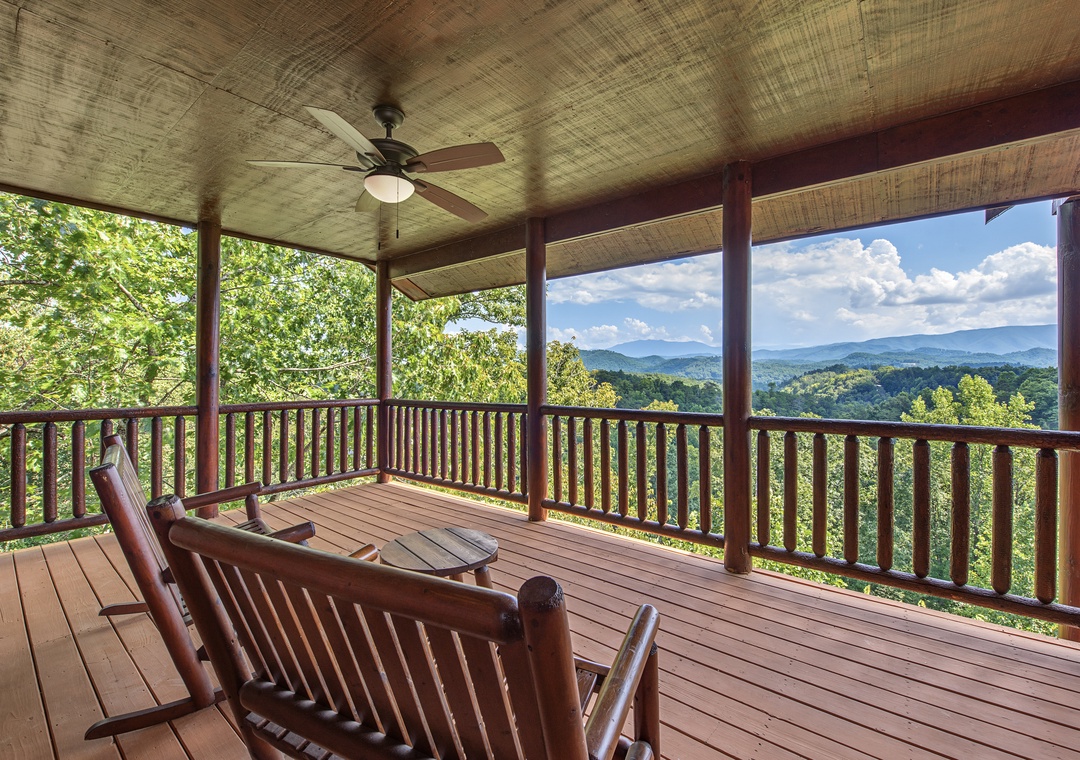 Unwind in your covered porch with sweeping mountain views that stretch across lush valleys and rolling peaks. The gentle ceiling fan and cozy seating invite you to sip your morning coffee or catch the evening breeze in total serenity.