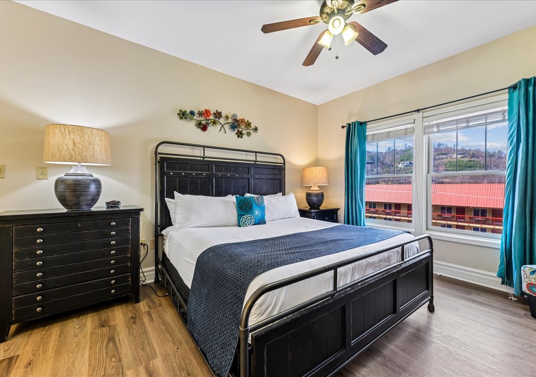 Your stylish bedroom features a plush bed with crisp linens, warm lighting, and vibrant turquoise accents that create a welcoming retreat.