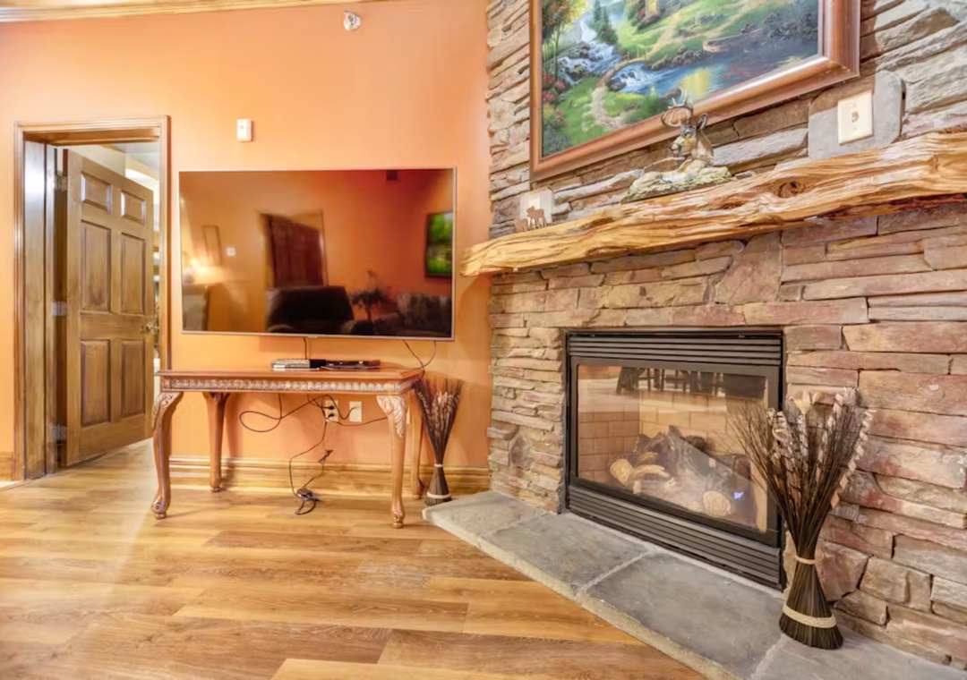Unwind by your stunning stone fireplace while watching TV from the elegant living area with gleaming hardwood floors.