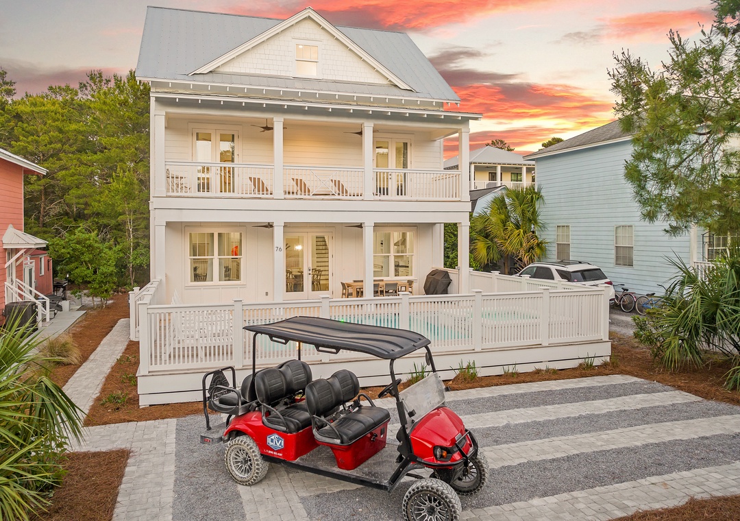 Charming two-story coastal home with private pool, wraparound porches, and golf cart for easy beach exploration.