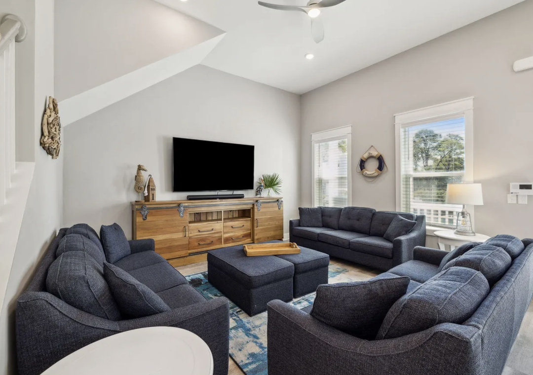 Sink into plush seating in your spacious living room, where vaulted ceilings and abundant natural light create an airy retreat for relaxing together after exploring.