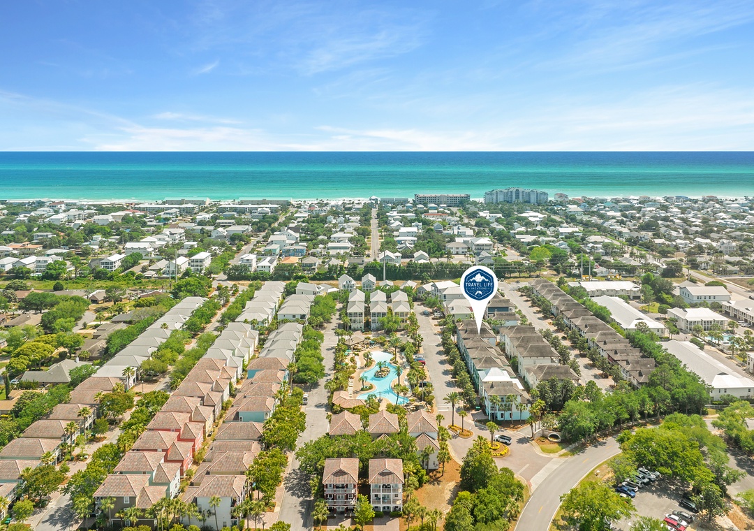 Aerial view of the property nestled in a coastal community, just a short distance from pristine turquoise waters and sandy beaches.