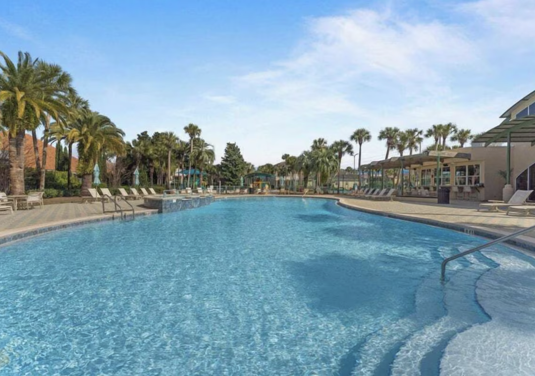 Sparkling pool surrounded by swaying palms and sunny loungers—perfect for leisurely afternoons cooling off in the Florida sunshine. Relax poolside or take a refreshing dip anytime.