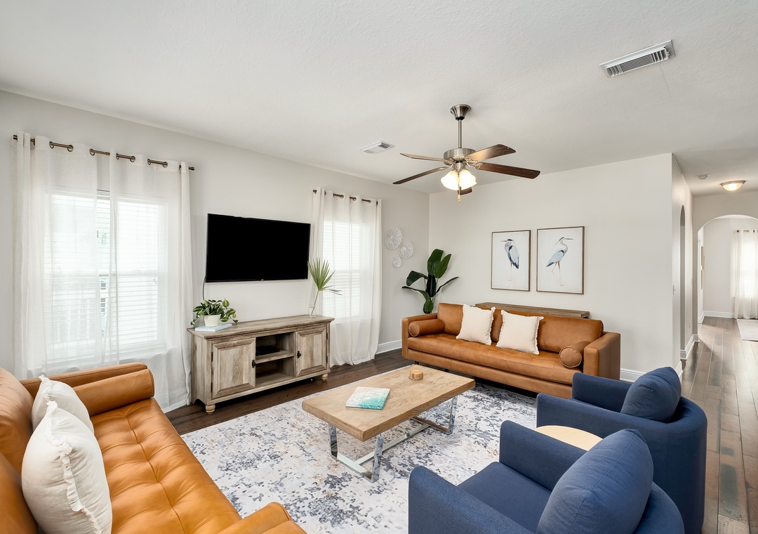 Relax in your beautifully furnished living room, where plush seating and warm natural light create the perfect space to unwind after exploring the area.